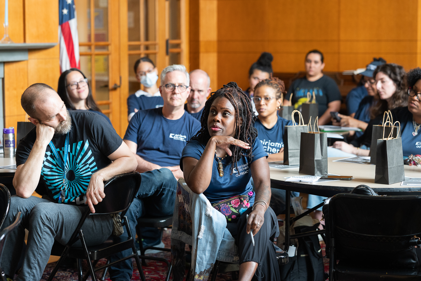 Audience listening closely during a Builder's Circle style workshop